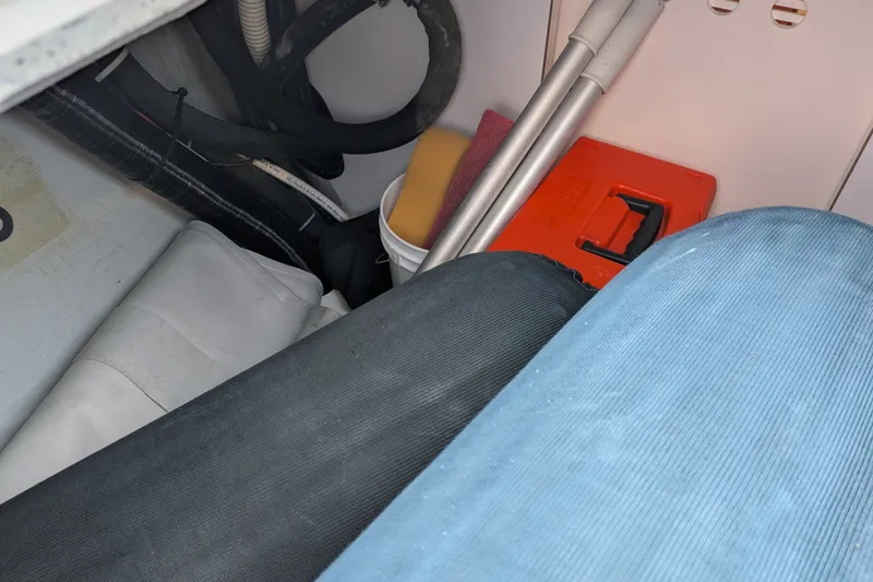 Slide: The Image of Storage compartment in a 2005 C&C 115 sailboat with tools and equipment. - 19