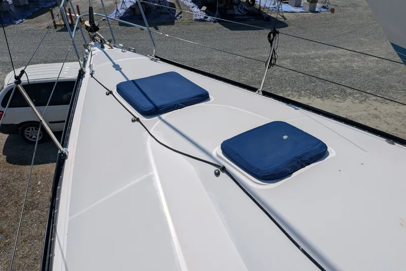 Slide: The Image of Deck of a 2005 C&C 115 sailboat with blue cushions and rigging. - 29