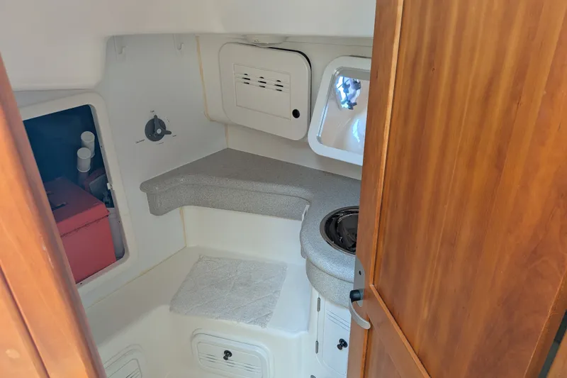 Slide: The Image of Compact galley kitchen in 2005 C&C 115 sailboat with wooden cabinetry and countertop. - 48