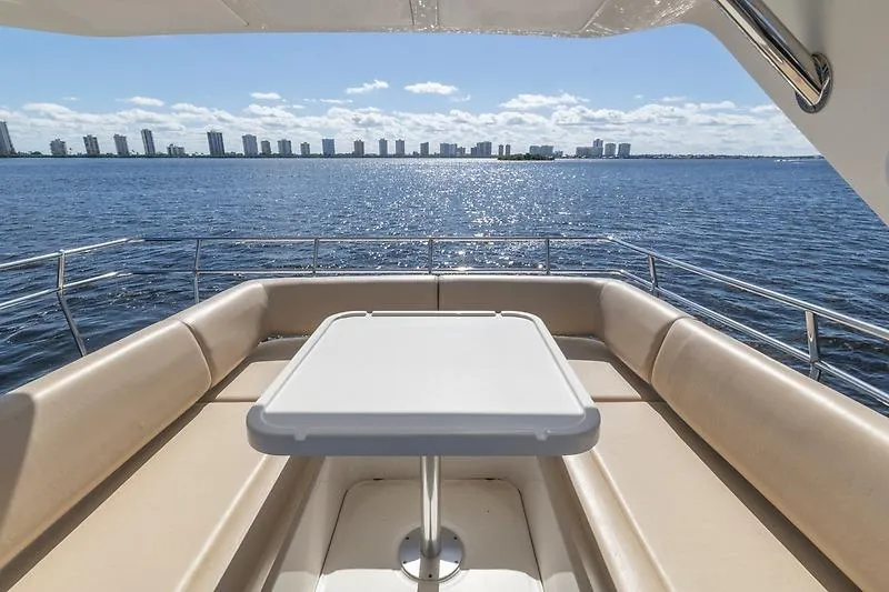 Slide: The Image of Luxurious seating area on 2016 Sea Ray 510 Fly yacht overlooking ocean and skyline. - 14
