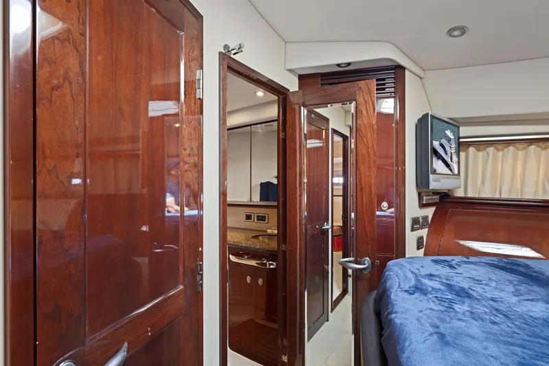 Slide: The Image of Luxurious interior of 2007 Sea Ray 58 Sedan Bridge yacht with wood finishes and cozy bedding. - 54