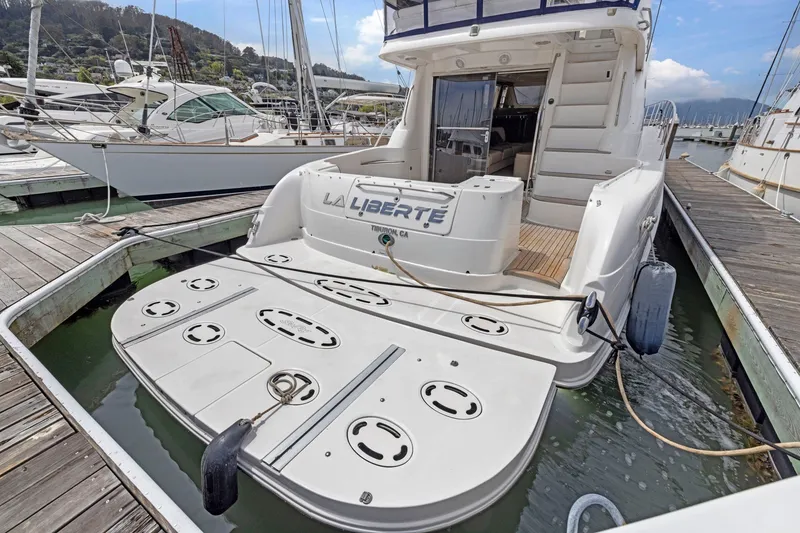 Slide: The Image of 2007 Sea Ray 58 Sedan Bridge yacht docked at marina, rear view. - 26