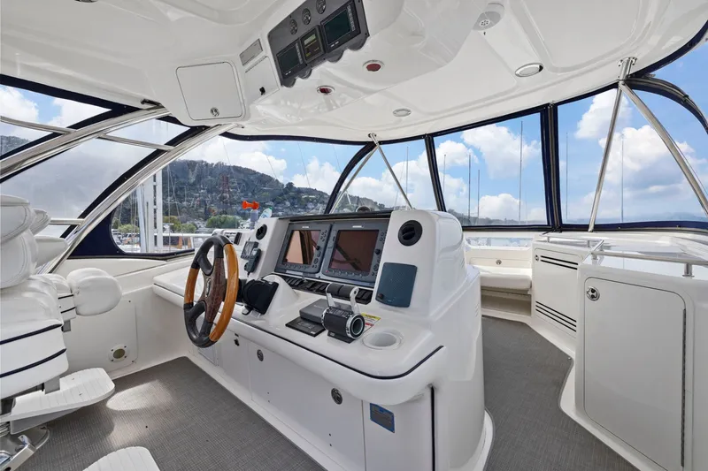Slide: The Image of 2007 Sea Ray 58 Sedan Bridge helm with modern navigation equipment and panoramic views. - 62