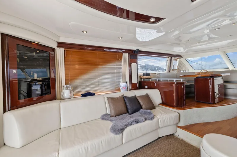Slide: The Image of Luxurious interior of 2007 Sea Ray 58 Sedan Bridge yacht with elegant seating and wooden accents. - 32