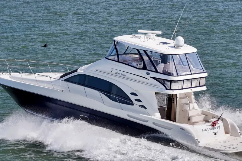 Slide: The Image of 2007 Sea Ray 58 Sedan Bridge yacht cruising on open water. - 8