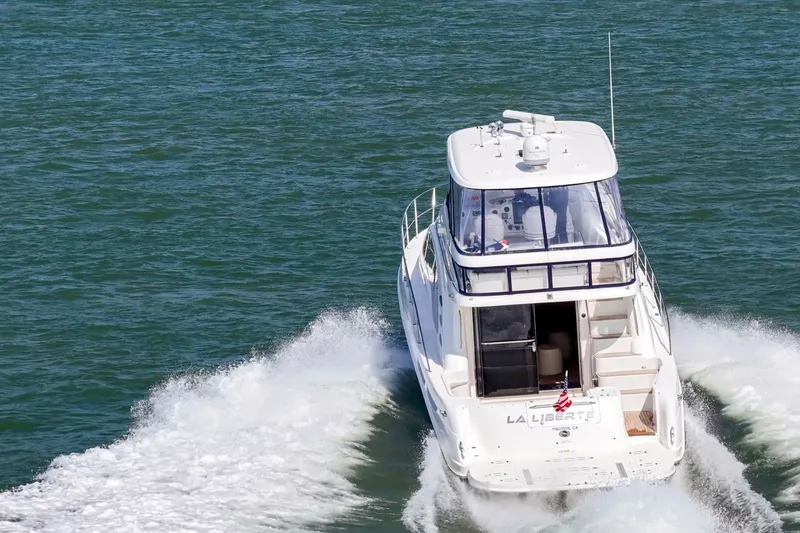 Slide: The Image of 2007 Sea Ray 58 Sedan Bridge cruising on open water, rear view. - 13