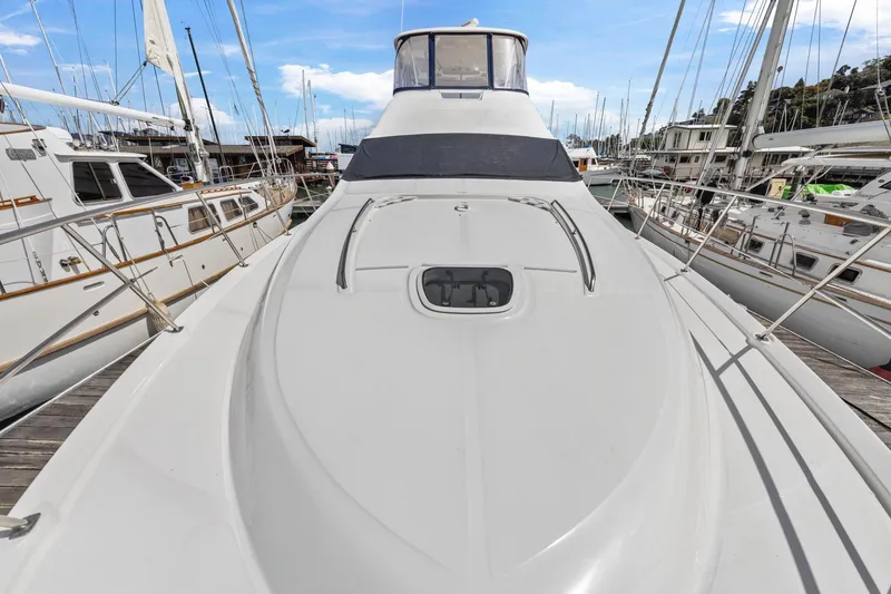 Slide: The Image of 2007 Sea Ray 58 Sedan Bridge yacht docked at marina, surrounded by sailboats. - 71