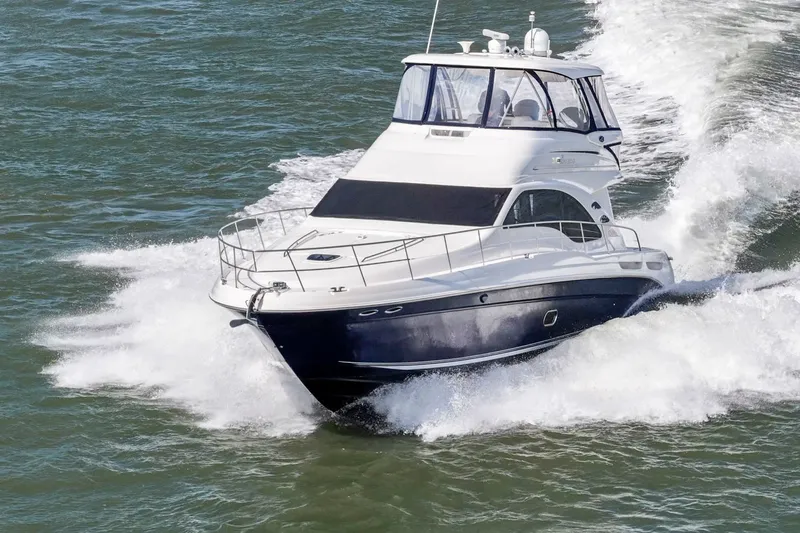 Slide: The Image of 2007 Sea Ray 58 Sedan Bridge yacht cruising on open water. - 9