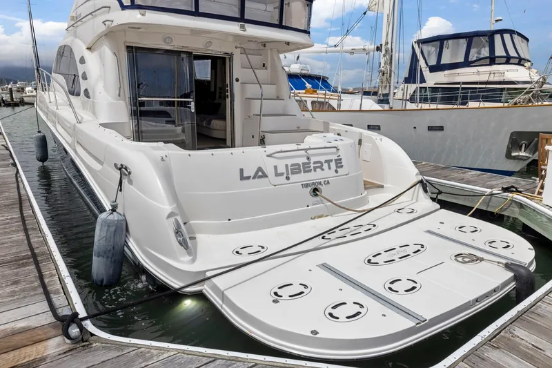 Slide: The Image of 2007 Sea Ray 58 Sedan Bridge yacht docked at marina, rear view. - 23