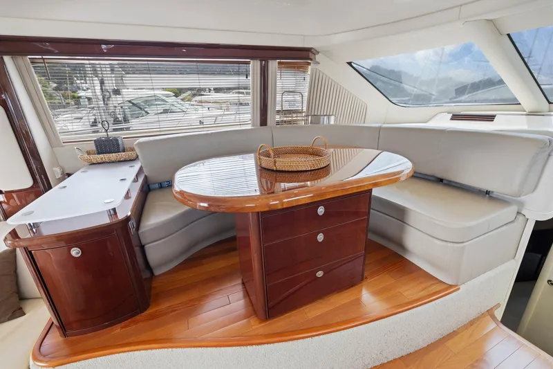 Slide: The Image of Luxurious interior of 2007 Sea Ray 58 Sedan Bridge yacht with elegant seating and wooden table. - 38
