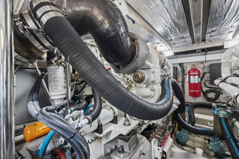 Slide: The Image of Engine room of 2007 Sea Ray 58 Sedan Bridge yacht, featuring complex machinery and fire extinguisher. - 79