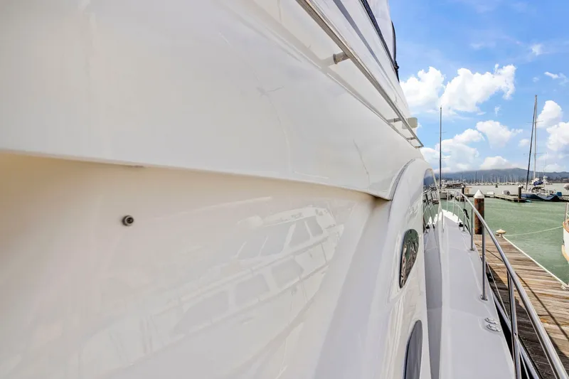 Slide: The Image of 2007 Sea Ray 58 Sedan Bridge yacht docked at marina under blue sky. - 68