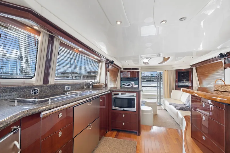 Slide: The Image of Luxurious interior of 2007 Sea Ray 58 Sedan Bridge yacht with modern kitchen and seating area. - 40