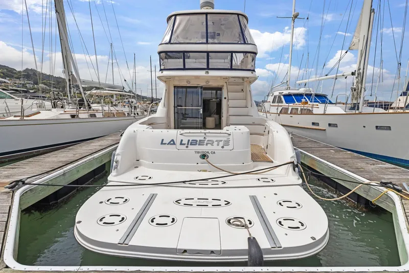 Slide: The Image of 2007 Sea Ray 58 Sedan Bridge yacht docked at marina, rear view. - 25