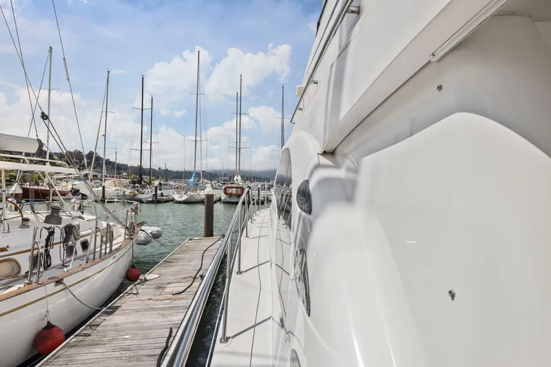 Slide: The Image of 2007 Sea Ray 58 Sedan Bridge yacht docked at a marina with sailboats. - 75