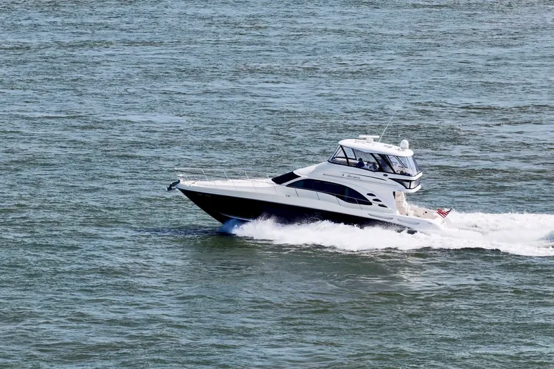 Slide: The Image of 2007 Sea Ray 58 Sedan Bridge yacht cruising on open water. - 11