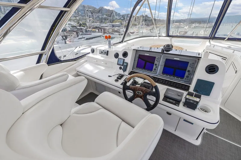 Slide: The Image of 2007 Sea Ray 58 Sedan Bridge helm with dual navigation screens and luxurious seating. - 66