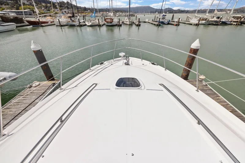 Slide: The Image of 2007 Sea Ray 58 Sedan Bridge yacht docked at a marina with scenic views. - 72