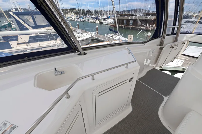 Slide: The Image of 2007 Sea Ray 58 Sedan Bridge yacht interior with sink and marina view. - 64