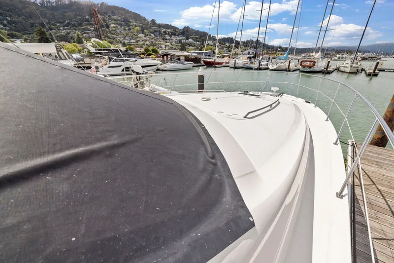Slide: The Image of 2007 Sea Ray 58 Sedan Bridge yacht docked at a marina with scenic hillside views. - 73