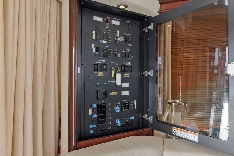 Slide: The Image of Electrical panel inside 2007 Sea Ray 58 Sedan Bridge yacht, featuring switches and controls. - 33