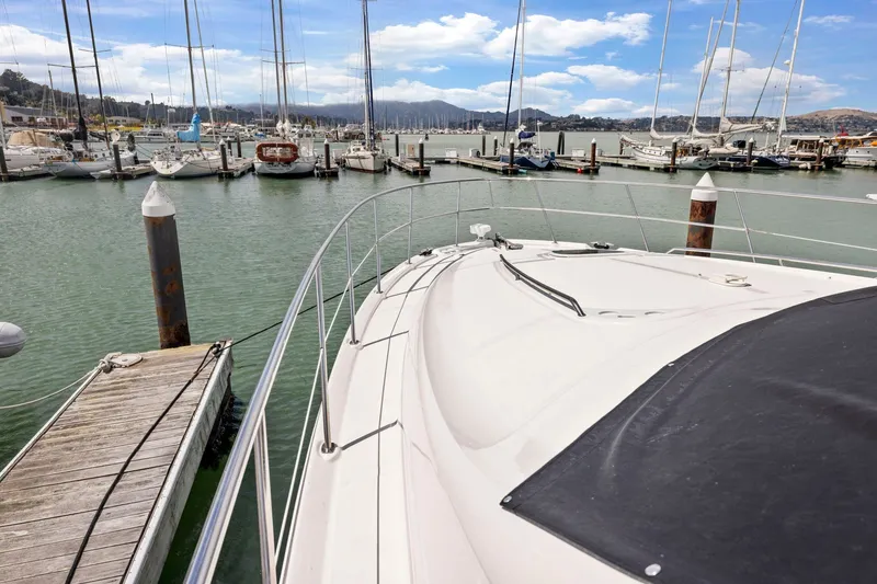 Slide: The Image of 2007 Sea Ray 58 Sedan Bridge yacht docked in a marina with sailboats. - 74