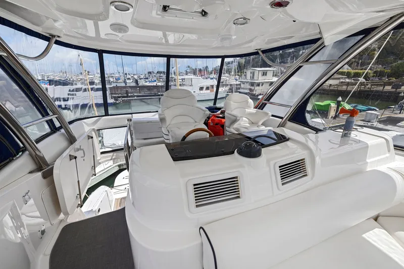 Slide: The Image of Luxurious interior of a 2007 Sea Ray 58 Sedan Bridge yacht at a marina. - 65