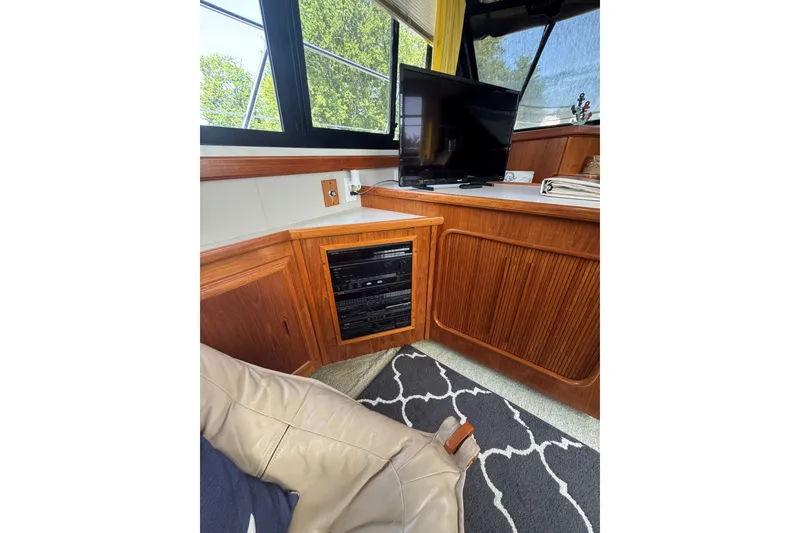 Slide: The Image of Interior of 1990 Carver 3807 Aft Cabin Motor Yacht with TV and wooden cabinetry. - 22