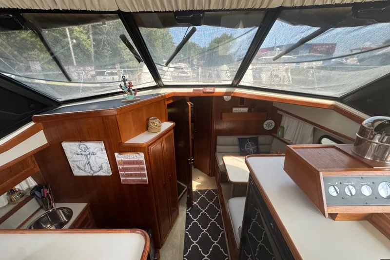 Slide: The Image of Interior of 1990 Carver 3807 Aft Cabin Motor Yacht with wood accents and nautical decor. - 15