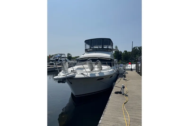 Slide: The Image of 1990 Carver 3807 Aft Cabin Motor Yacht docked at marina. - 2
