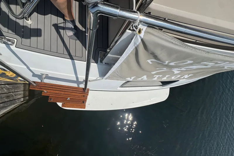 Slide: The Image of 1990 Carver 3807 Aft Cabin Motor Yacht docked, showing deck and water reflection. - 10