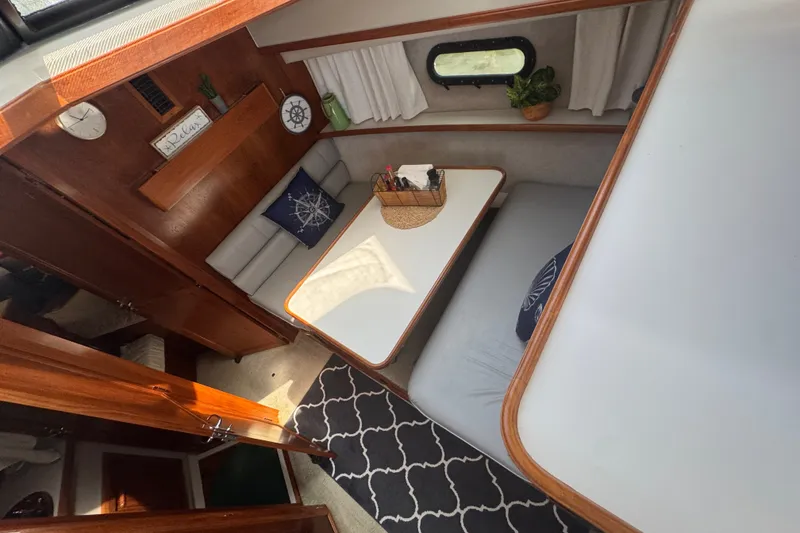 Slide: The Image of Interior of 1990 Carver 3807 Aft Cabin Motor Yacht with cozy seating and nautical decor. - 16