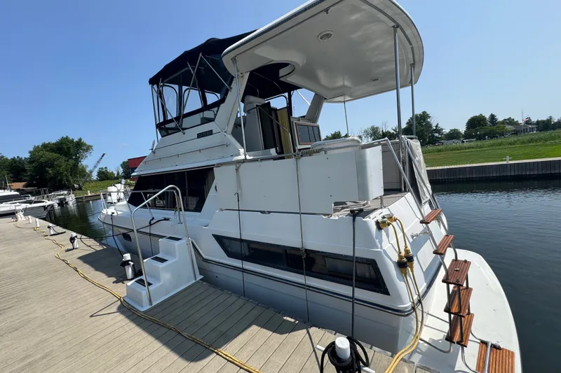Slide: The Image of 1990 Carver 3807 Aft Cabin Motor Yacht docked at marina, side view. - 6