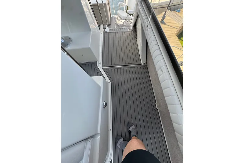 Slide: The Image of 1990 Carver 3807 Aft Cabin Motor Yacht deck with modern flooring and seating. - 45