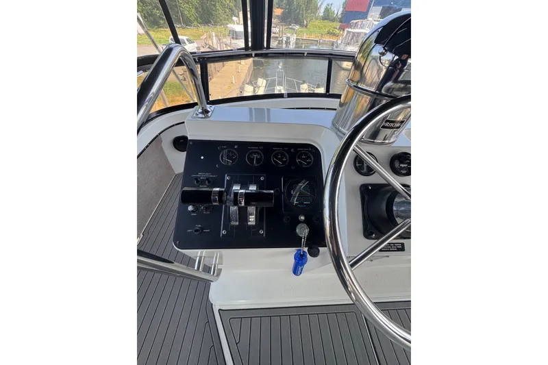 Slide: The Image of Helm of 1990 Carver 3807 Aft Cabin Motor Yacht with steering wheel and control panel. - 47