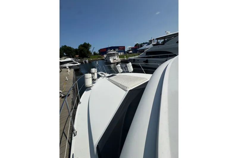 Slide: The Image of 1990 Carver 3807 Aft Cabin Motor Yacht docked at marina under clear sky. - 11