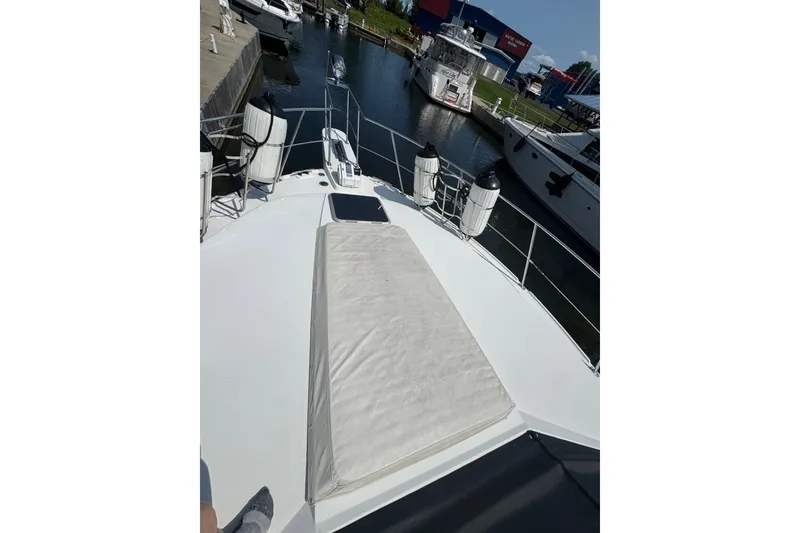 Slide: The Image of 1990 Carver 3807 Aft Cabin Motor Yacht docked at marina, view from bow deck. - 13