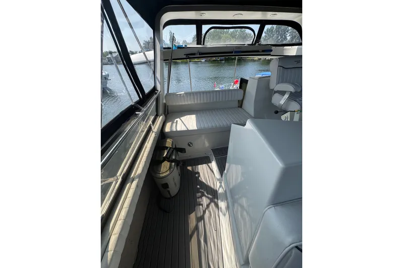 Slide: The Image of 1990 Carver 3807 Aft Cabin Motor Yacht interior with seating and water view. - 40
