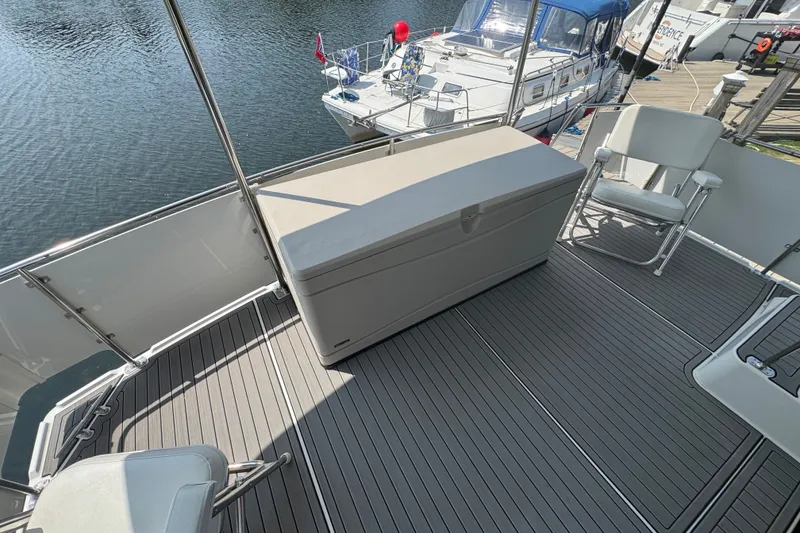 Slide: The Image of 1990 Carver 3807 Aft Cabin Motor Yacht deck with seating and storage box. - 32
