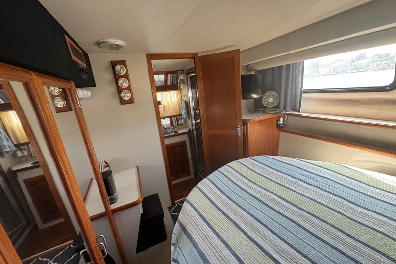 Slide: The Image of Interior of 1990 Carver 3807 Aft Cabin Motor Yacht with cozy bedroom and bathroom. - 24