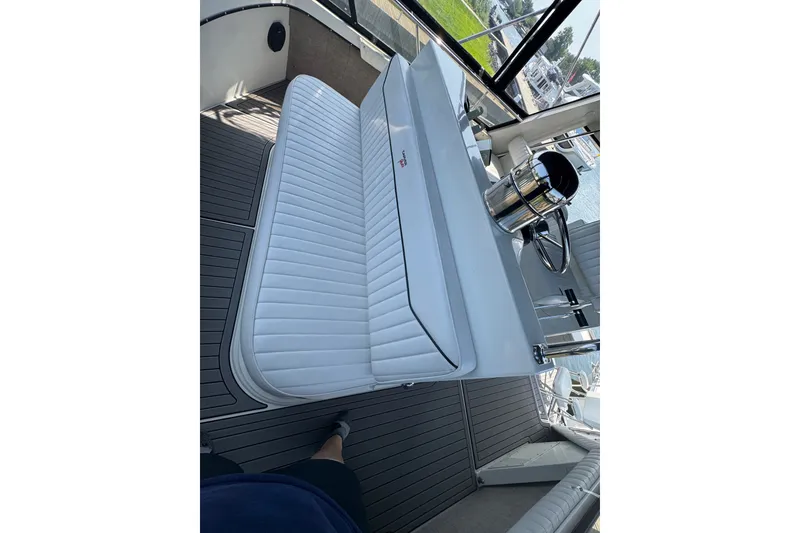 Slide: The Image of 1990 Carver 3807 Aft Cabin Motor Yacht interior with white seating and steering wheel. - 43