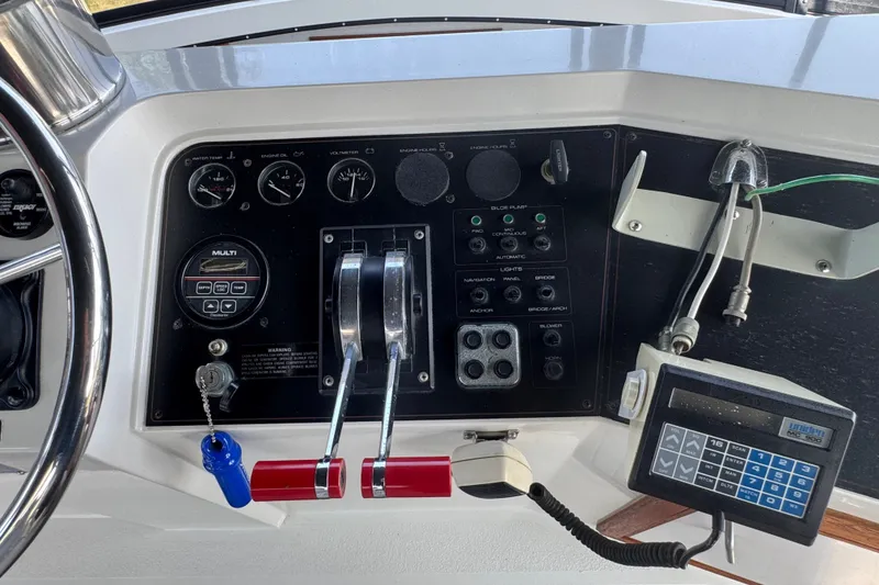 Slide: The Image of Control panel of a 1990 Carver 3807 Aft Cabin Motor Yacht with gauges and switches. - 39