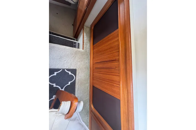 Slide: The Image of Interior of 1990 Carver 3807 Aft Cabin Motor Yacht with wooden cabinetry and carpeted flooring. - 23