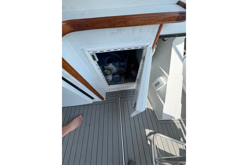 Slide: The Image of 1990 Carver 3807 Aft Cabin Motor Yacht interior storage compartment with open door. - 34