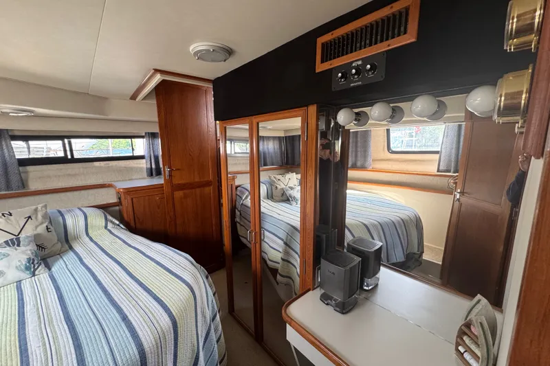Slide: The Image of Interior of 1990 Carver 3807 Aft Cabin Motor Yacht with cozy bedroom setup. - 28