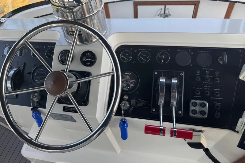 Slide: The Image of Steering wheel and control panel of a 1990 Carver 3807 Aft Cabin Motor Yacht. - 36