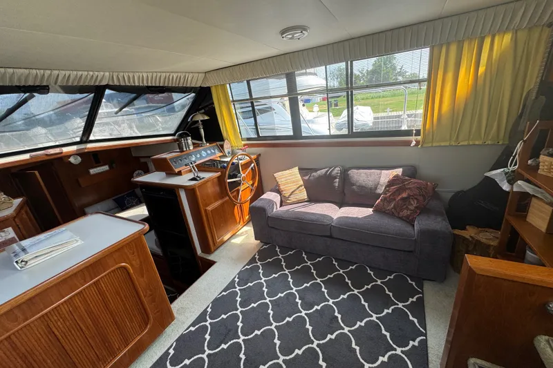 Slide: The Image of Interior of 1990 Carver 3807 Aft Cabin Motor Yacht with cozy seating and helm. - 21