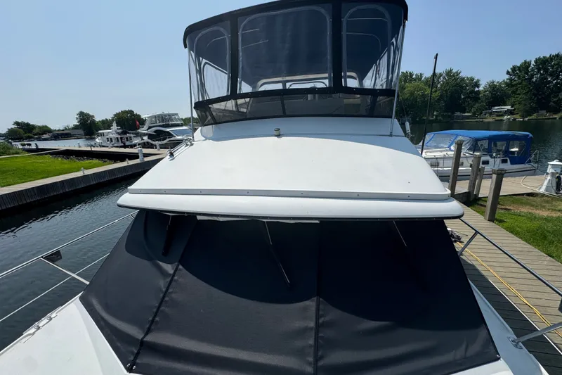 Slide: The Image of 1990 Carver 3807 Aft Cabin Motor Yacht docked at marina, sunny day. - 12