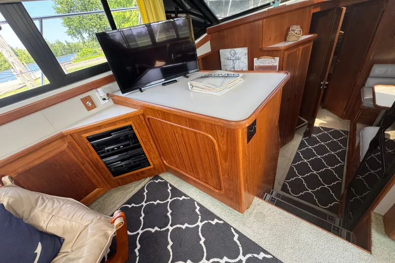 Slide: The Image of Interior of 1990 Carver 3807 Aft Cabin Motor Yacht with TV and wood cabinetry. - 18