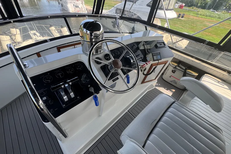 Slide: The Image of Helm of 1990 Carver 3807 Aft Cabin Motor Yacht with steering wheel and controls. - 46
